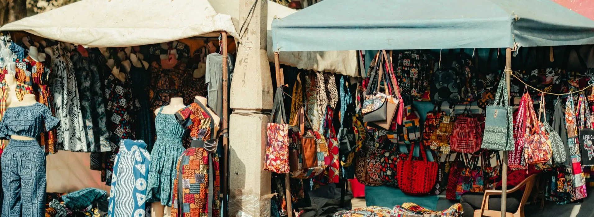 Market stalls in Nairobi hung with printed textiles, dresses and bags