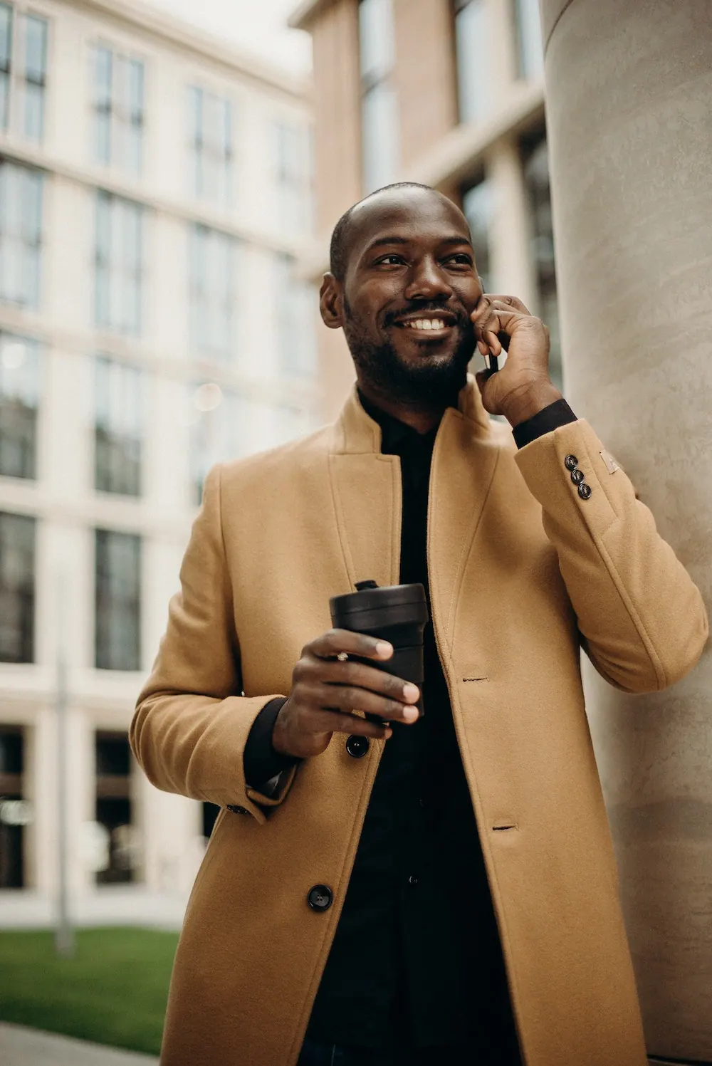 A man on his phone in a city street, exploring opportunities back on the continent