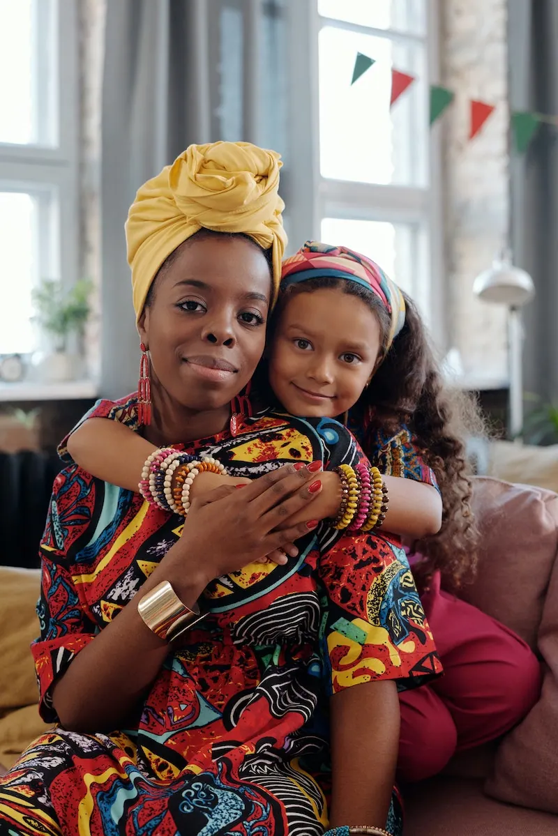 A mother and her daughter in headwraps, the Diaspora living outside the motherland